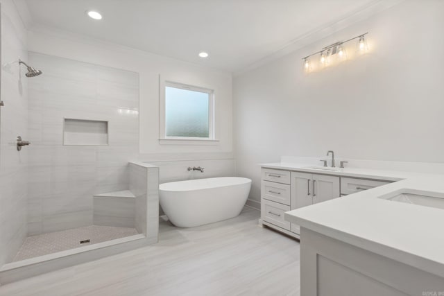 bathroom featuring vanity, ornamental molding, and independent shower and bath