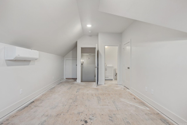 bonus room featuring a wall mounted AC and lofted ceiling