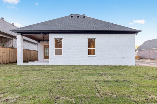 rear view of house featuring a lawn, ceiling fan, and a patio