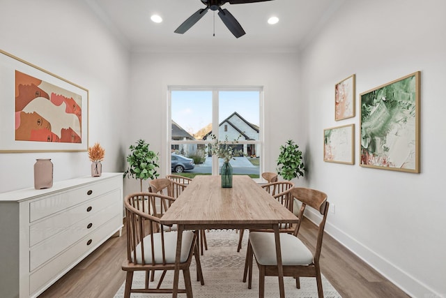 dining space with ceiling fan, wood-type flooring, and crown molding