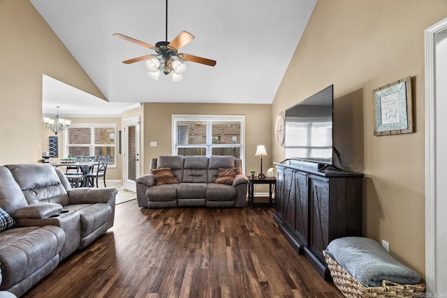 living room with ceiling fan with notable chandelier, high vaulted ceiling, and dark wood-type flooring