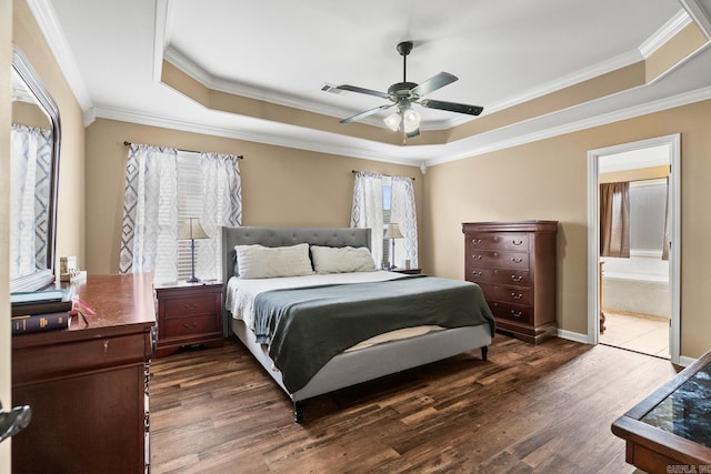 bedroom with ceiling fan, crown molding, dark wood-type flooring, and ensuite bath