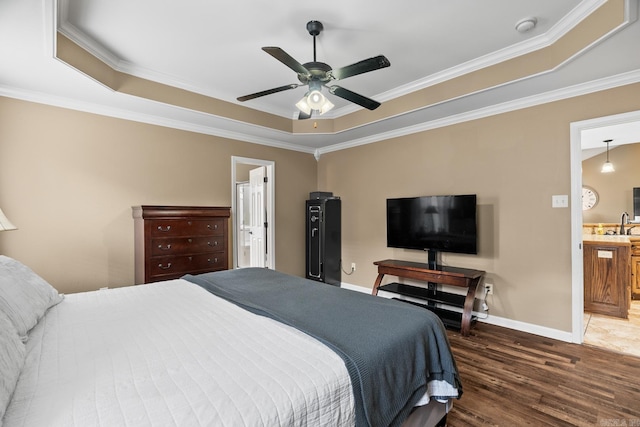 bedroom with a tray ceiling, ceiling fan, crown molding, and dark hardwood / wood-style floors