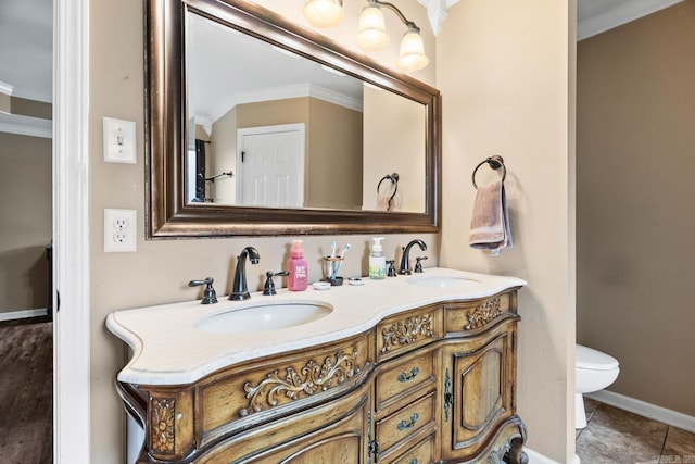 bathroom with tile patterned floors, vanity, toilet, and crown molding