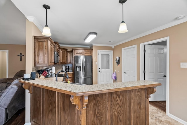 kitchen featuring kitchen peninsula, decorative backsplash, stainless steel appliances, and ornamental molding