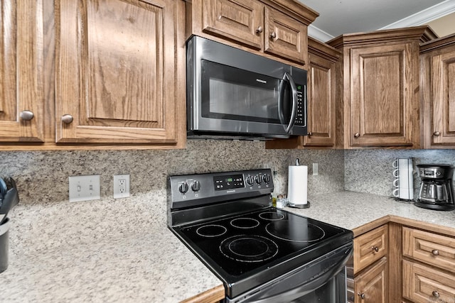 kitchen featuring backsplash, crown molding, and black range with electric cooktop