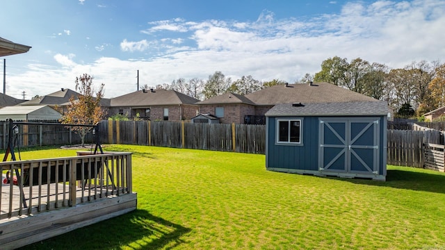 view of yard featuring a storage shed and a deck