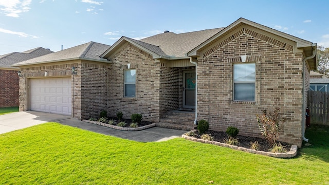 view of front of property featuring a garage and a front lawn