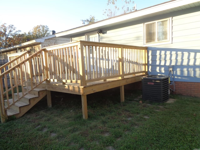 wooden terrace featuring central air condition unit and a lawn