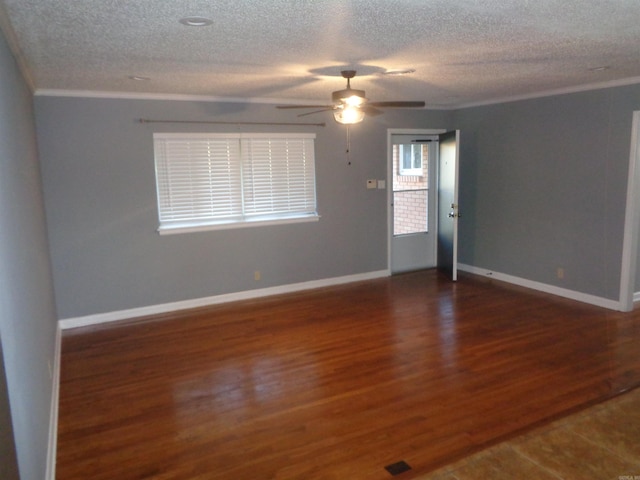 spare room with a textured ceiling, dark hardwood / wood-style flooring, ceiling fan, and ornamental molding