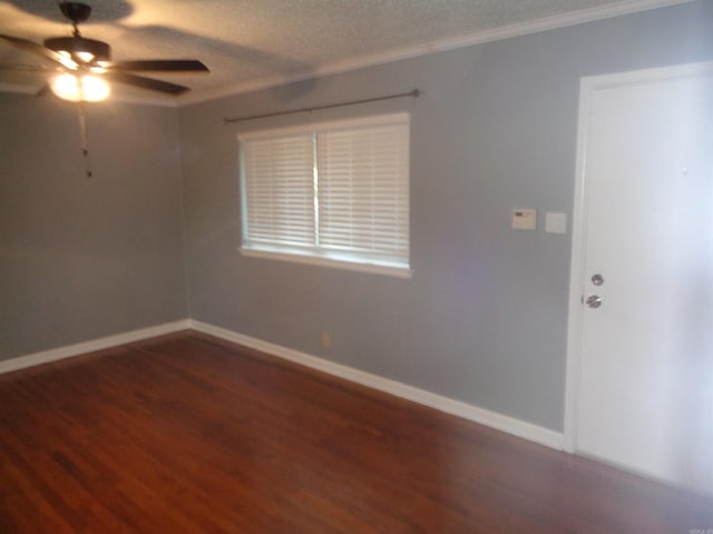 spare room with a textured ceiling, ceiling fan, ornamental molding, and dark wood-type flooring