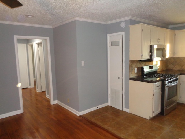 kitchen featuring crown molding, dark hardwood / wood-style floors, decorative backsplash, a textured ceiling, and appliances with stainless steel finishes