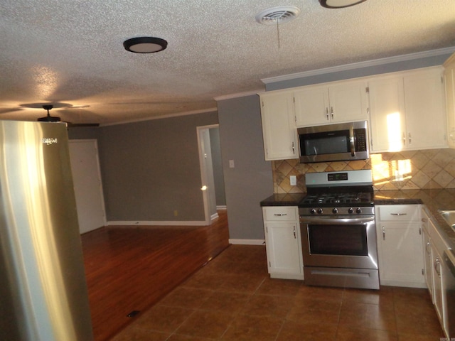 kitchen with white cabinetry, dark hardwood / wood-style flooring, and appliances with stainless steel finishes