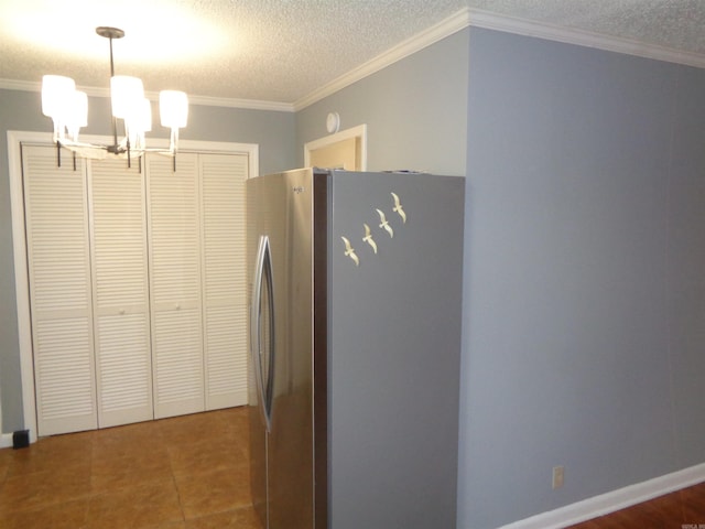 kitchen with tile patterned floors, stainless steel fridge, crown molding, and a chandelier