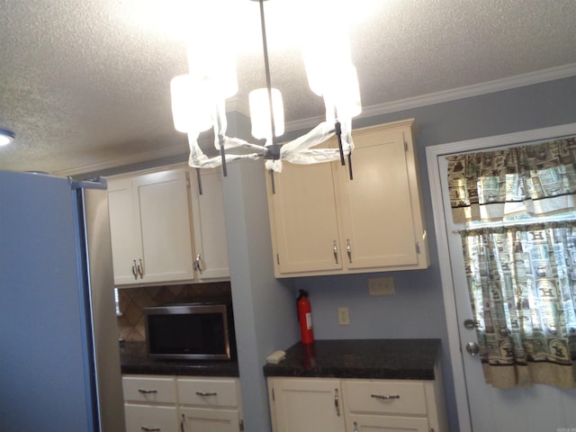 kitchen with white cabinetry, crown molding, a textured ceiling, and appliances with stainless steel finishes