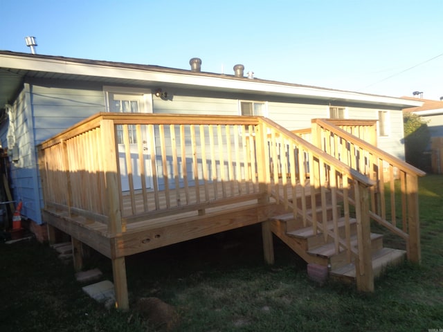 rear view of house featuring a wooden deck