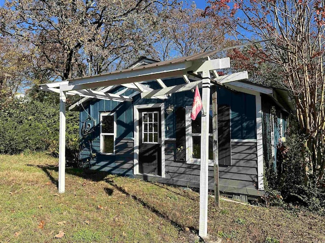 view of side of property with a lawn