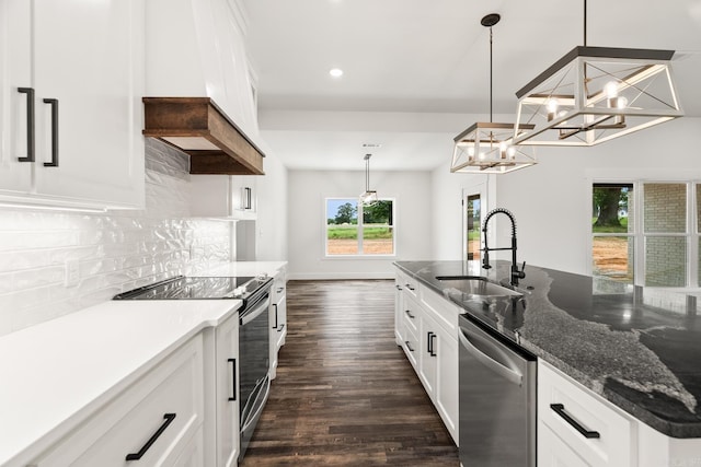 kitchen featuring pendant lighting, white cabinetry, sink, and appliances with stainless steel finishes