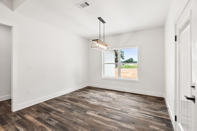 spare room featuring dark hardwood / wood-style flooring