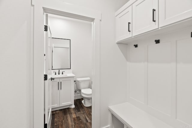 mudroom with dark hardwood / wood-style floors and sink