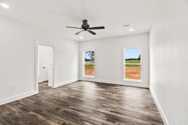 unfurnished room with ceiling fan and dark hardwood / wood-style flooring