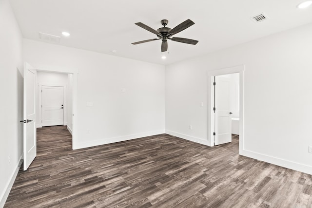 unfurnished room with ceiling fan and dark wood-type flooring