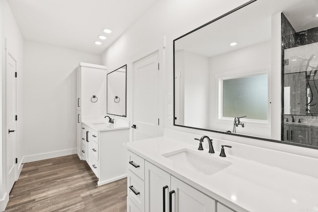 bathroom with vanity, wood-type flooring, and walk in shower