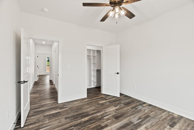 unfurnished bedroom featuring a closet, ceiling fan, and dark wood-type flooring