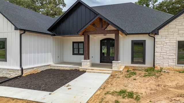 view of front of house with french doors and covered porch