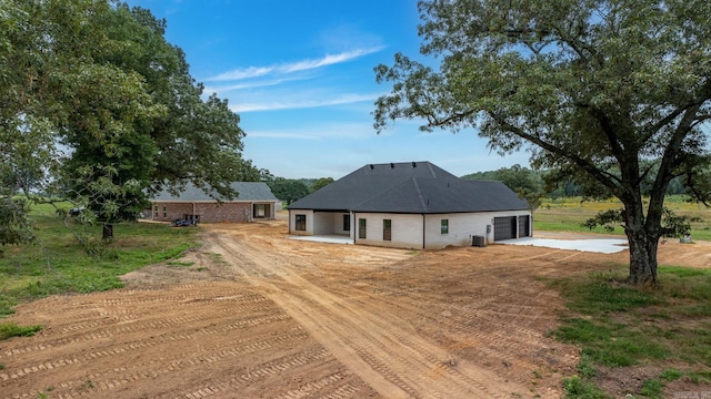 exterior space featuring a garage and central AC