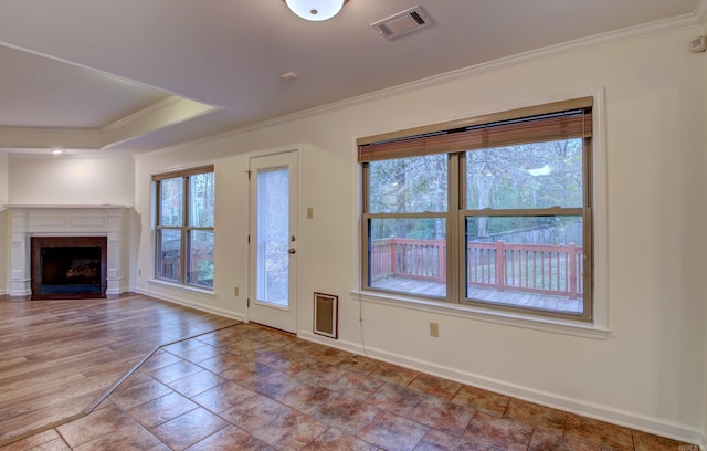 unfurnished living room with crown molding and light hardwood / wood-style floors