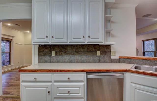 kitchen with white cabinets, hardwood / wood-style floors, stainless steel dishwasher, and plenty of natural light