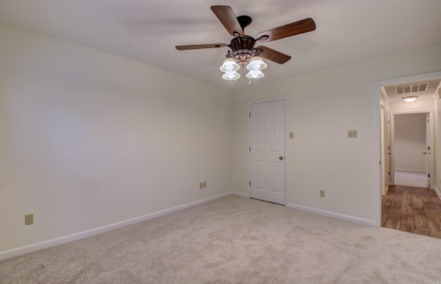 carpeted empty room featuring ceiling fan