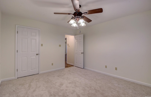 carpeted empty room featuring ceiling fan