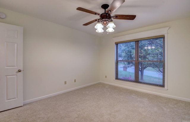 carpeted empty room with ceiling fan