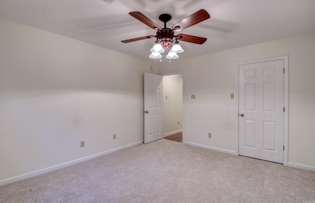 unfurnished room with ceiling fan and light carpet