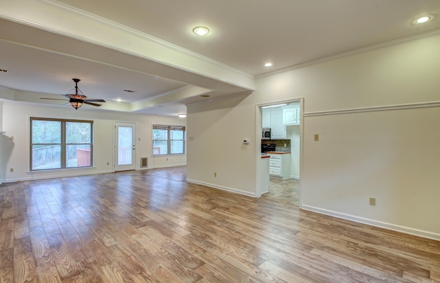 unfurnished living room with light wood-type flooring, ceiling fan, and crown molding