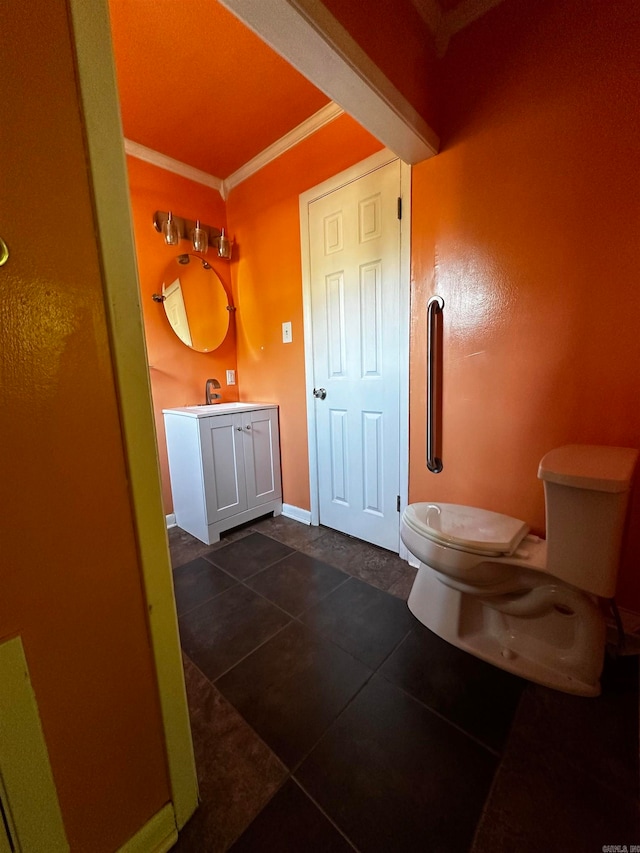 bathroom featuring tile patterned flooring, vanity, toilet, and ornamental molding