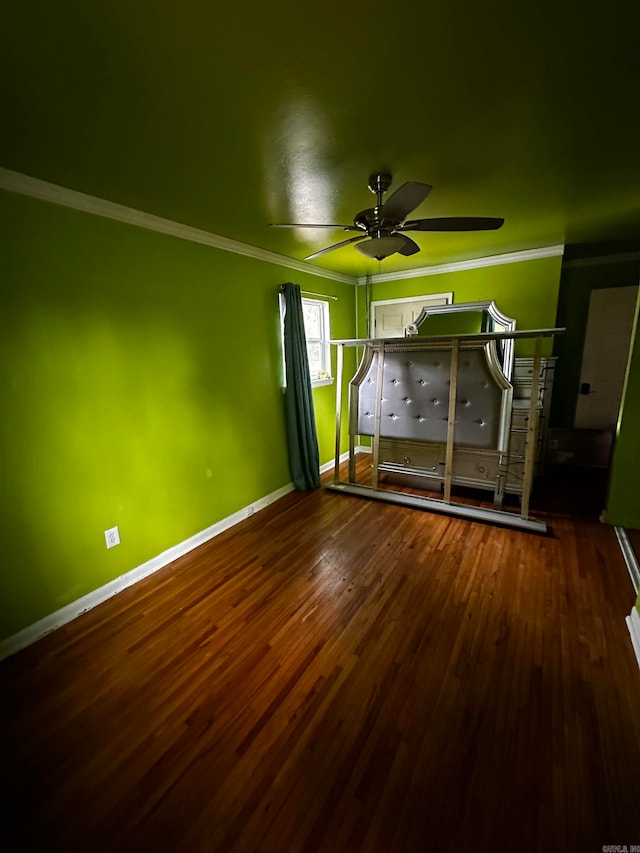 unfurnished bedroom featuring wood-type flooring and crown molding