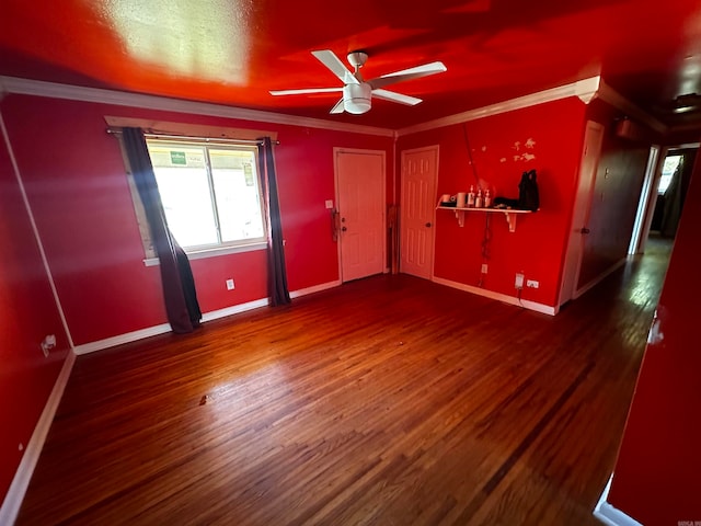 interior space featuring ceiling fan, ornamental molding, and dark wood-type flooring