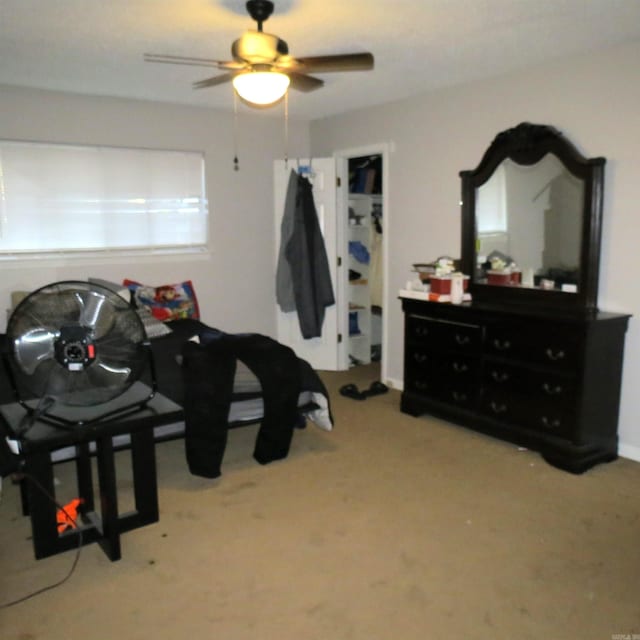 interior space with carpet flooring and ceiling fan