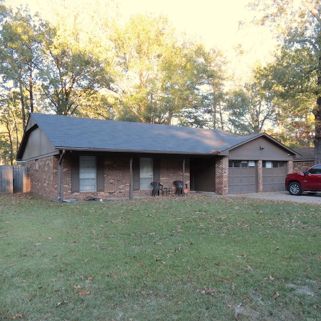 ranch-style house with a garage and a lawn