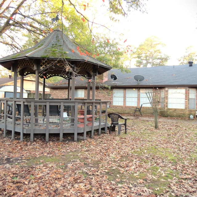 exterior space featuring a gazebo and a wooden deck