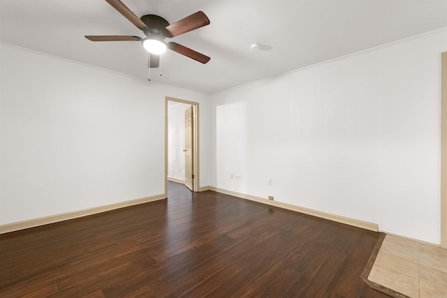 unfurnished room featuring ceiling fan, crown molding, and dark wood-type flooring