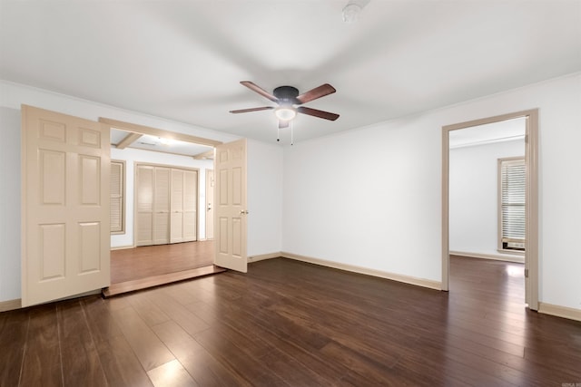 spare room featuring ceiling fan and dark wood-type flooring