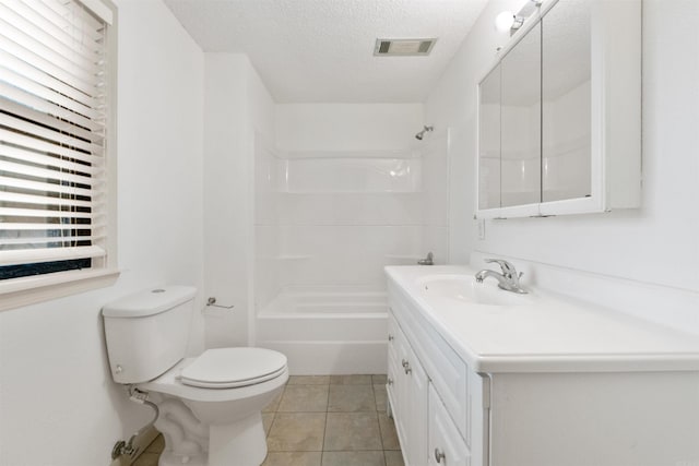 full bathroom featuring vanity, tile patterned floors, washtub / shower combination, toilet, and a textured ceiling