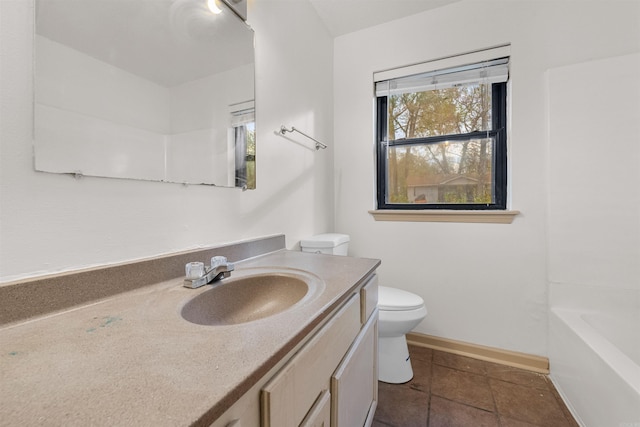 bathroom with tile patterned flooring, vanity, and toilet