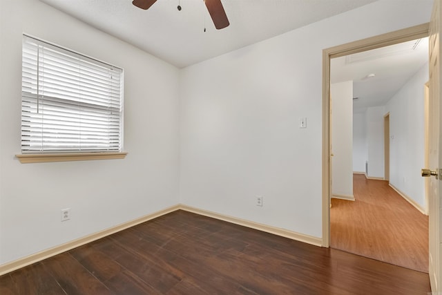 unfurnished room featuring dark hardwood / wood-style floors and ceiling fan