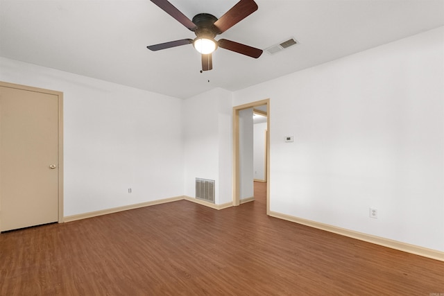 empty room with dark hardwood / wood-style floors and ceiling fan