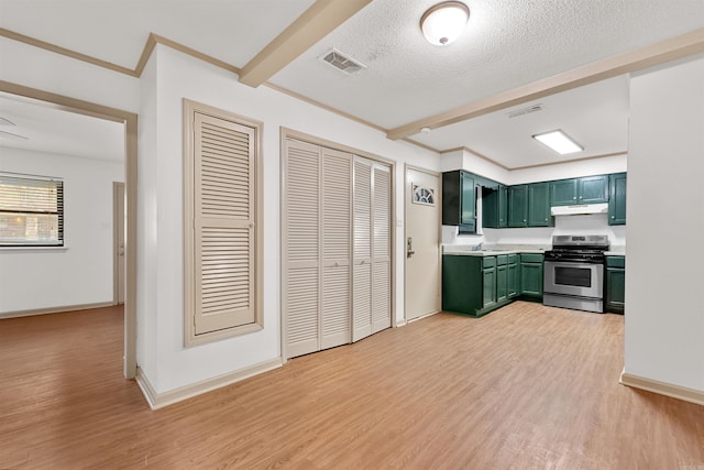 kitchen with beamed ceiling, stainless steel range oven, light hardwood / wood-style floors, a textured ceiling, and green cabinetry